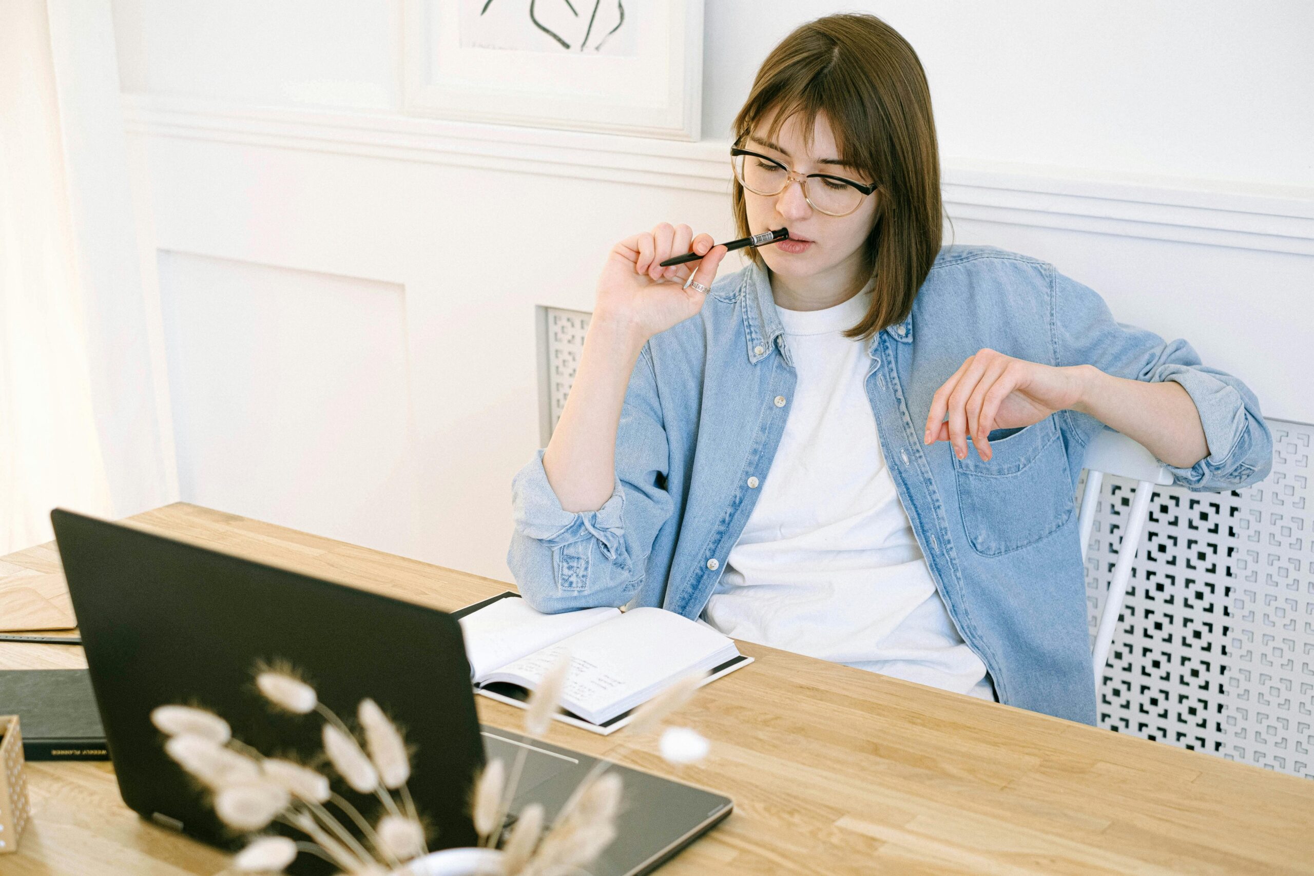 person typing on laptop at desk for solo business productivity