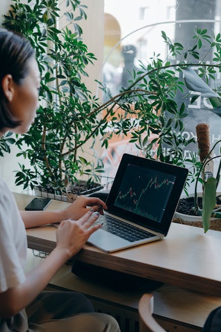 entrepreneur reviewing financial graphs and passive income streams on laptop