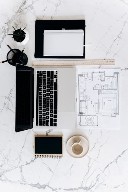 Minimalist workspace setup for running a one-person business with laptop and coffee