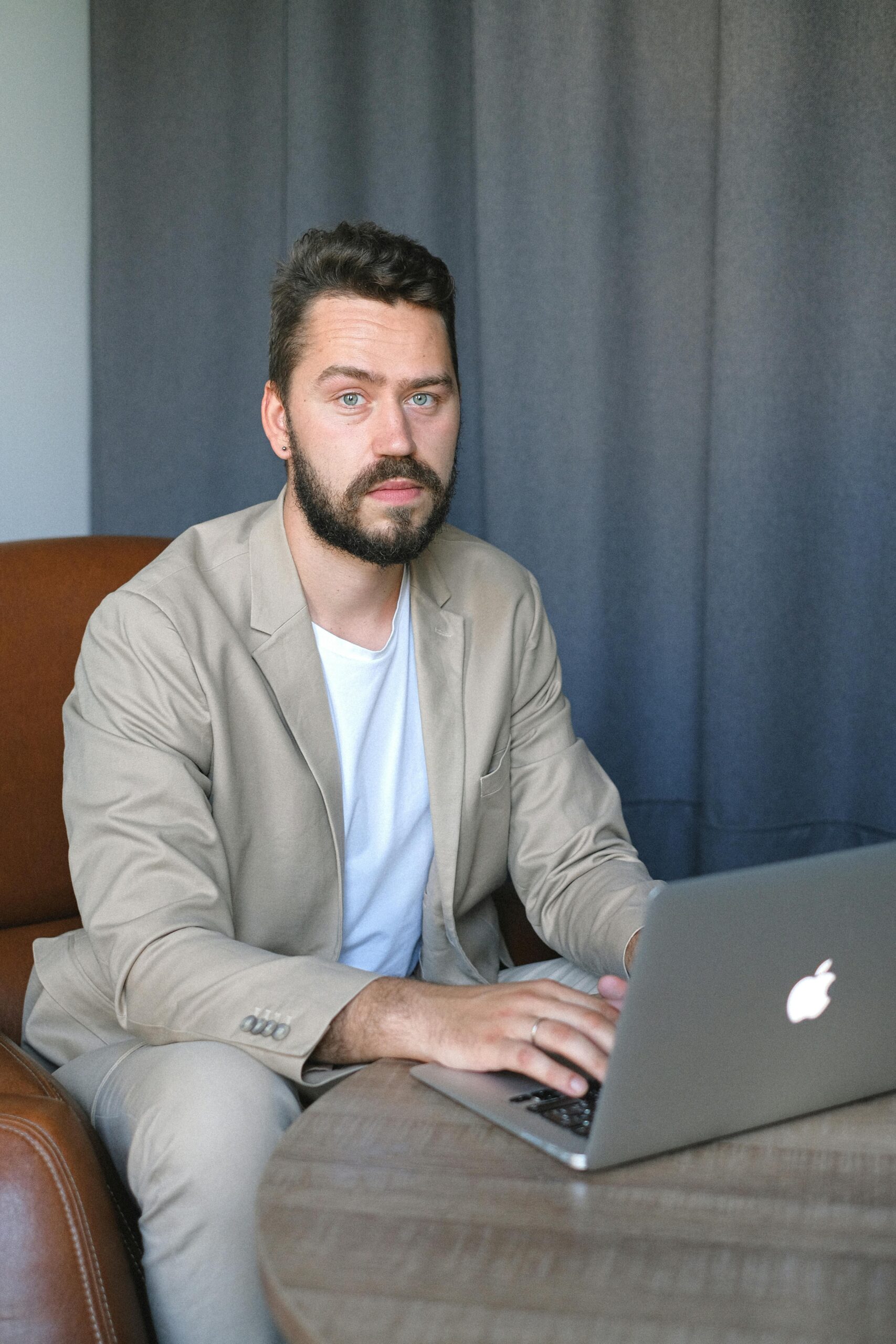 Young entrepreneur using laptop for AI-powered solo business operations