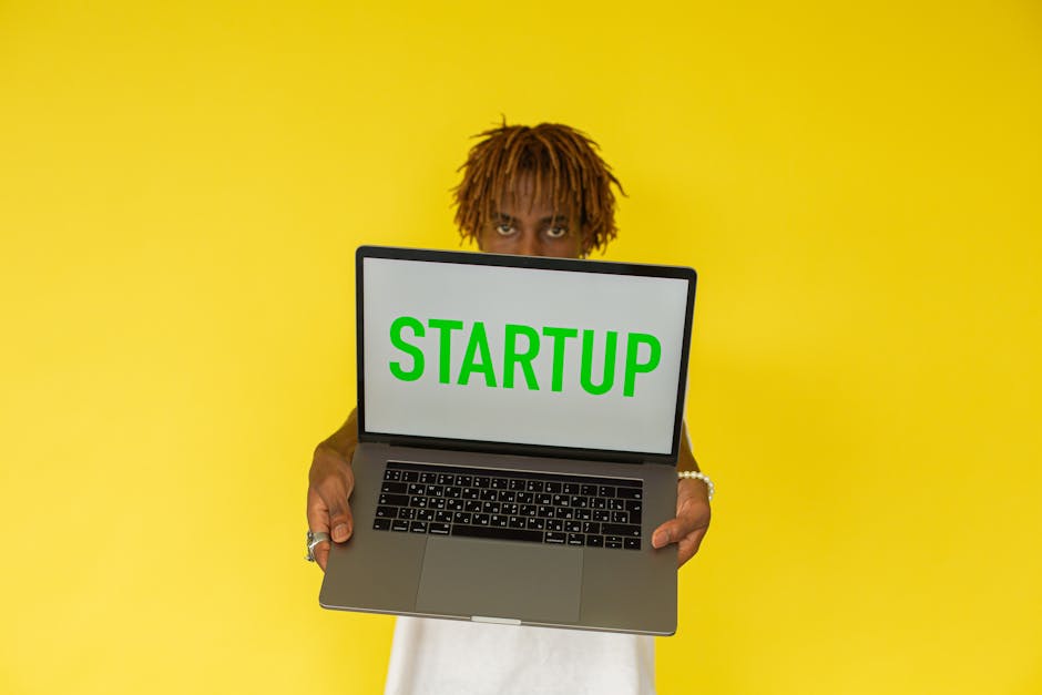 Young entrepreneur holding startup laptop building solo AI business