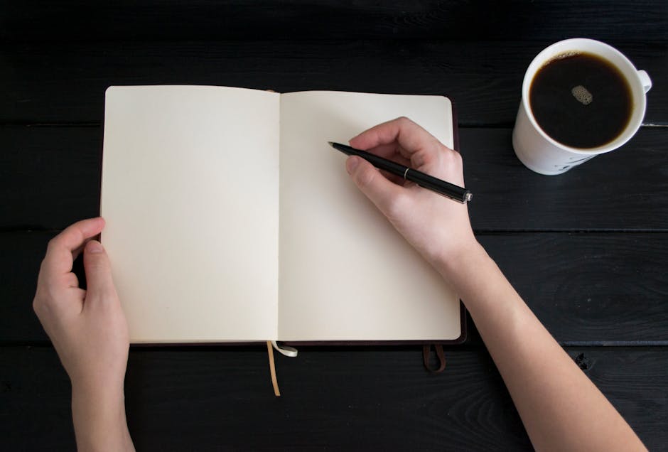 Solo founder writing newsletter with coffee and notebook