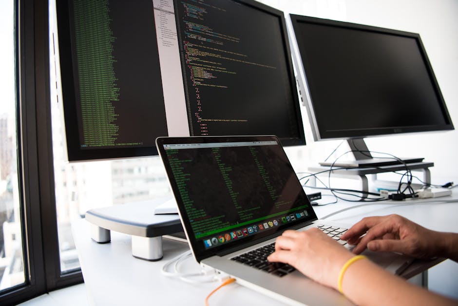 Developer using AI coding tools on multiple screens