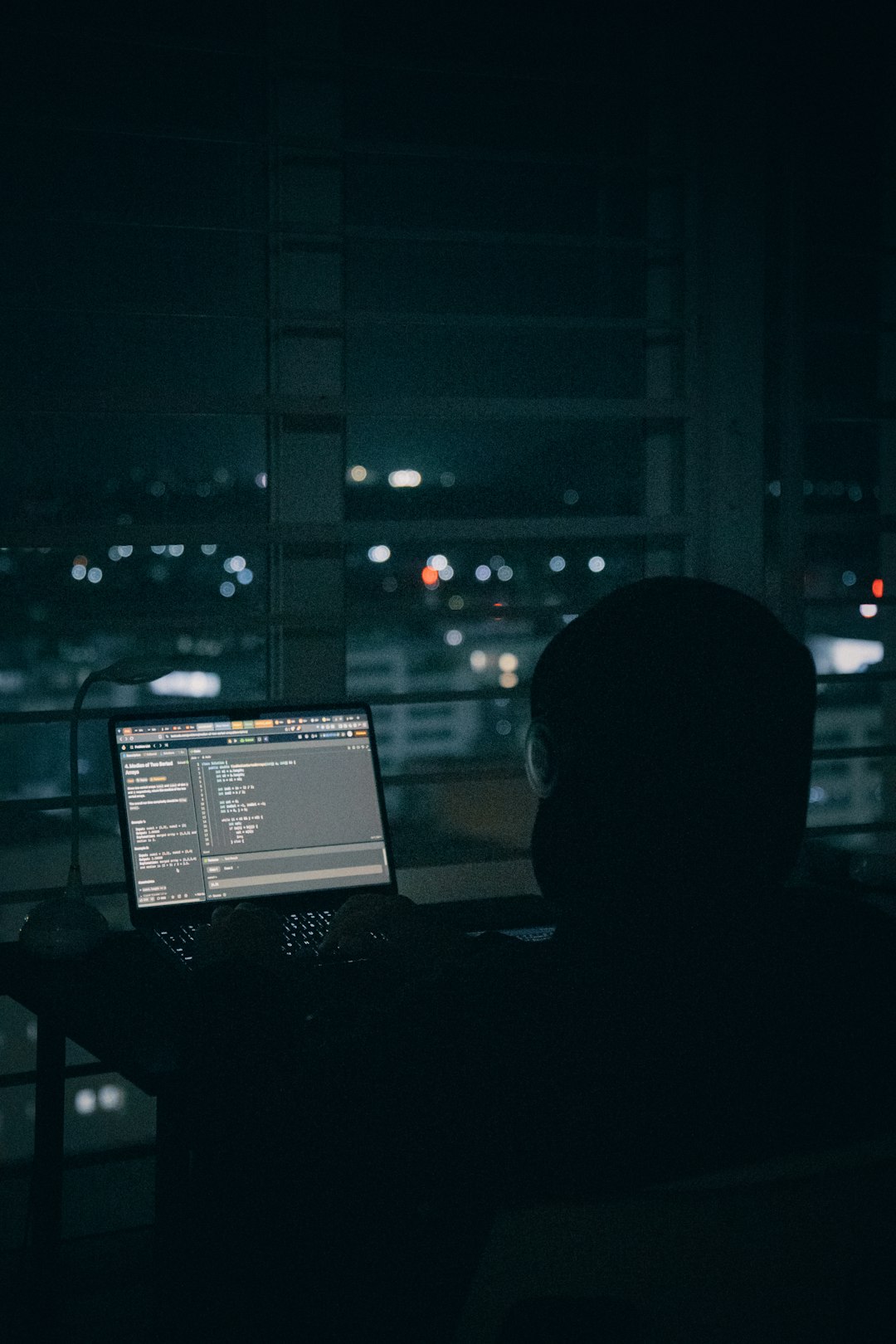 Solo founder coding late at night while AI agents run launch tasks in background