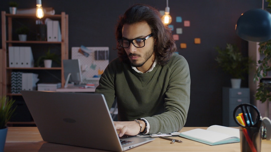 Solopreneur typing on laptop using ChatGPT memory and personalization at night