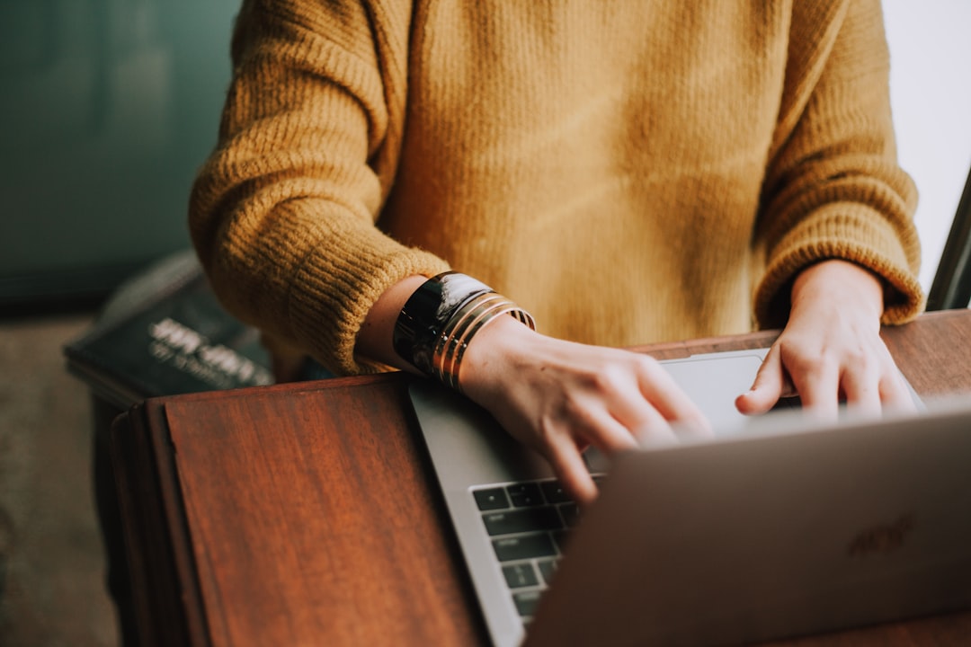 Person working on laptop scaling solo business to success with AI tools